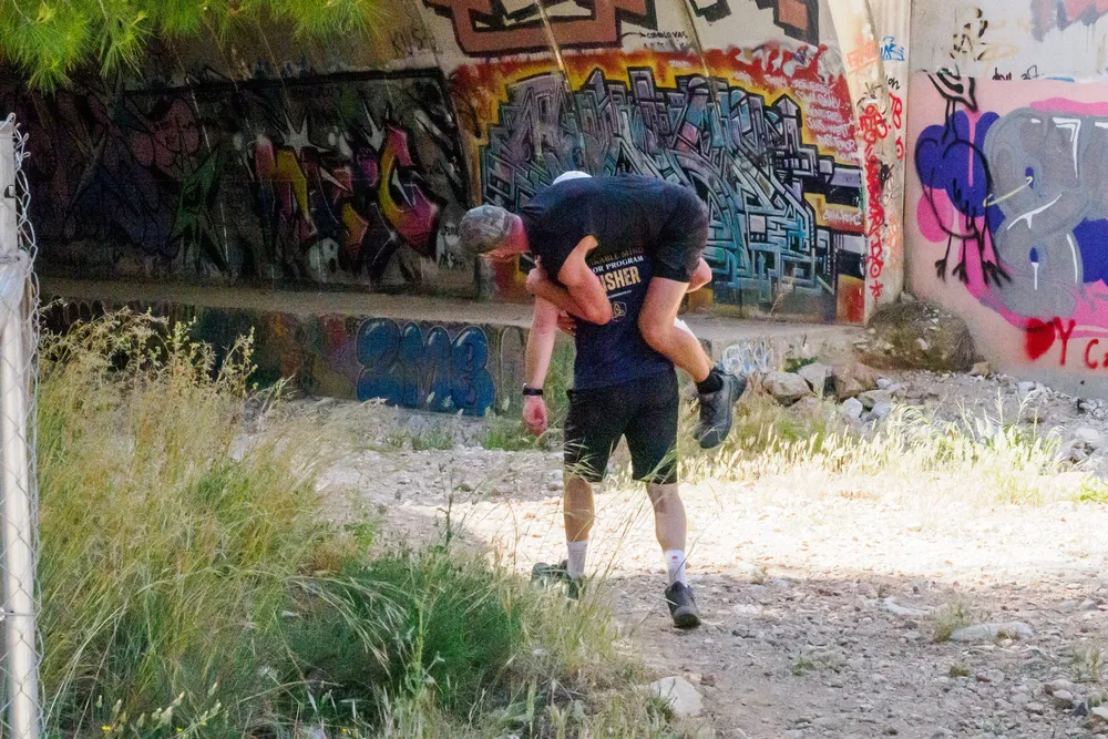 A team carrying a load together under stress