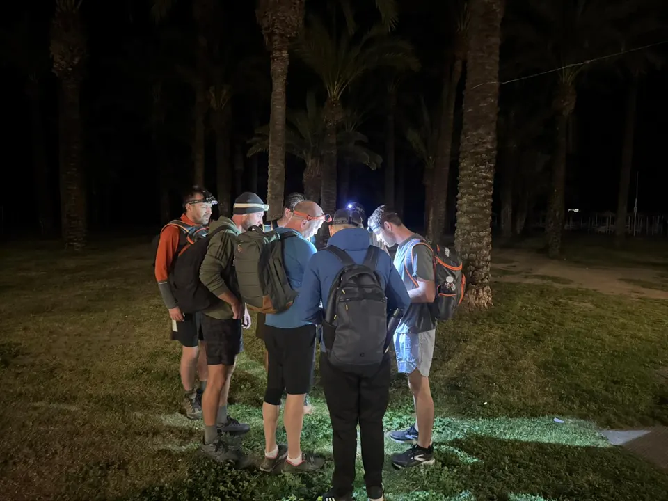The cohort training together on the beach at night